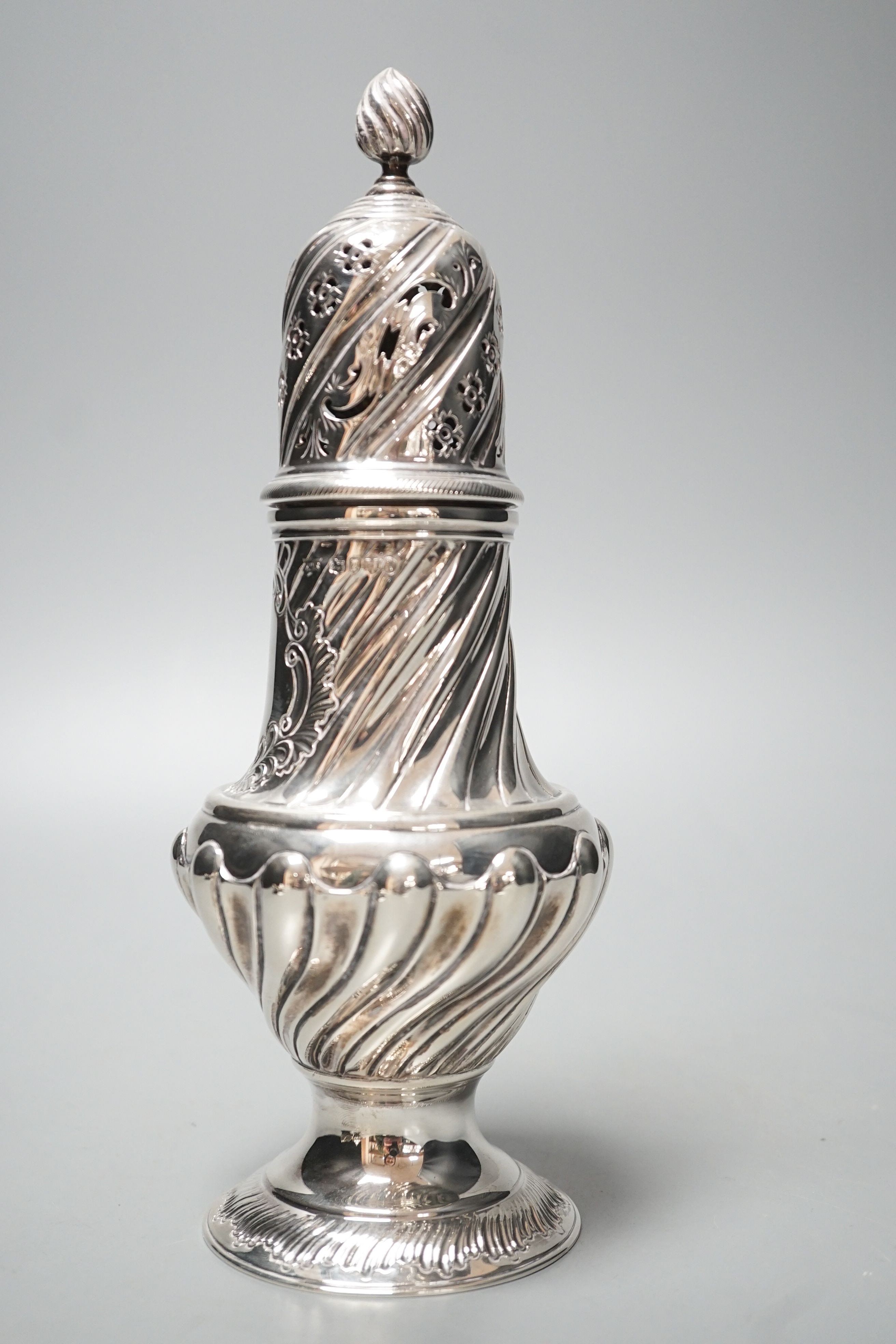 A large Victorian repousse silver sugar caster, London, 1887, 22.7cm, 8.5oz.